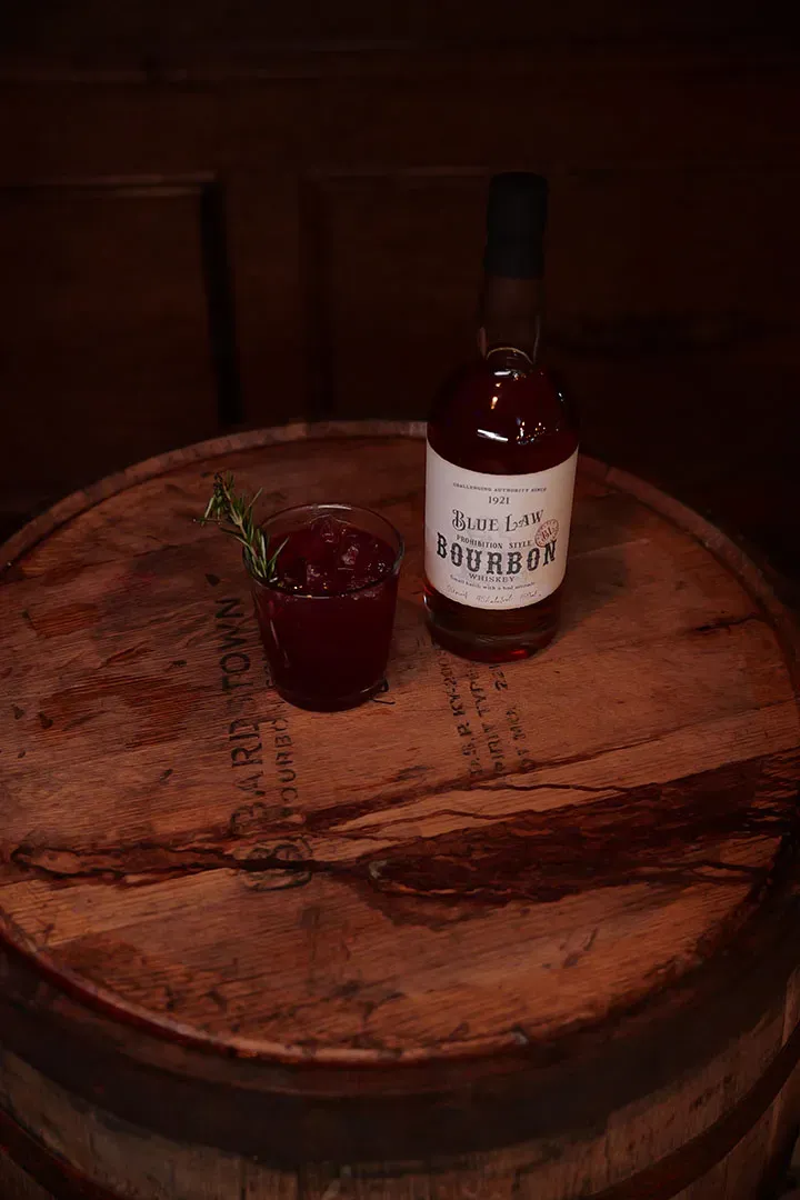 Rosemary cocktail with bourbon on barrel